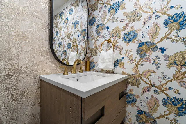 a kitchen with white cabinets and window