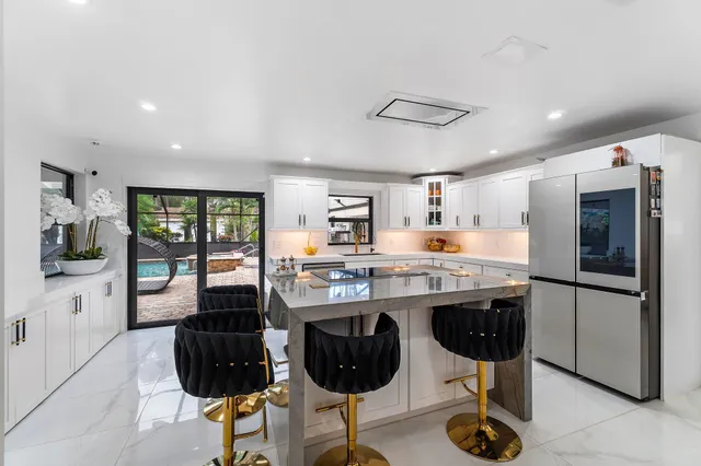 a spacious bedroom with a bed and a flat tv screen next to a window