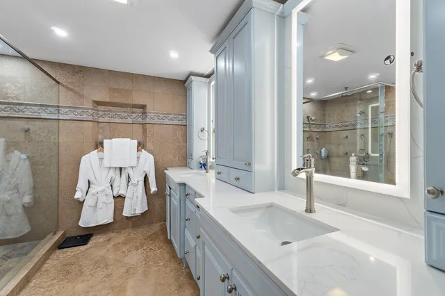 a bathroom with a sink a toilet and shower