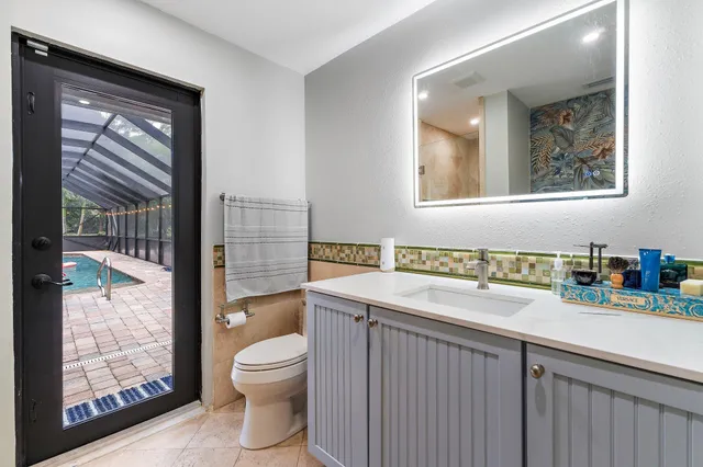 a view of a backyard with potted plants and large trees