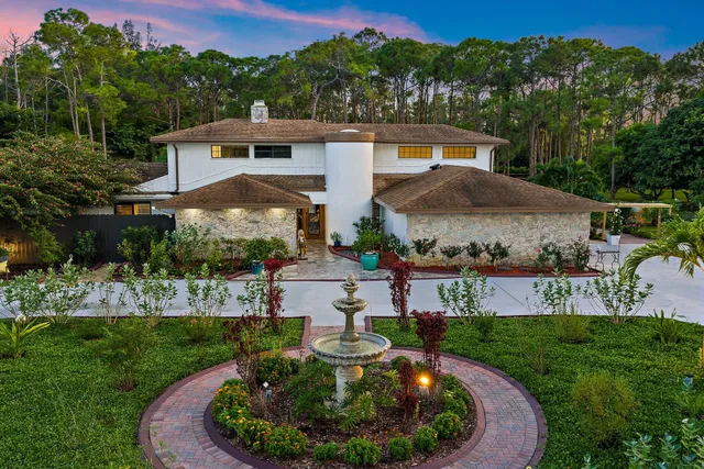 an aerial view of a house with pool yard and outdoor seating