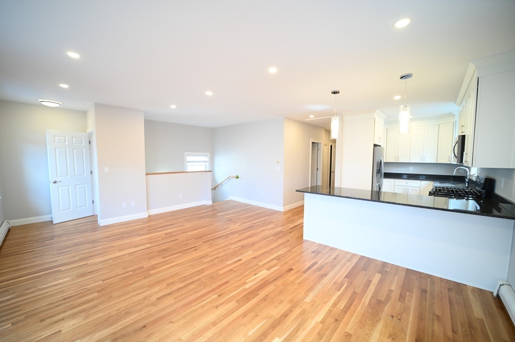 19 Roberts Street, Unit 3 Brookline, MA 02445 - Photo 1 of 10 a view of kitchen with kitchen island wooden floor appliances and center island