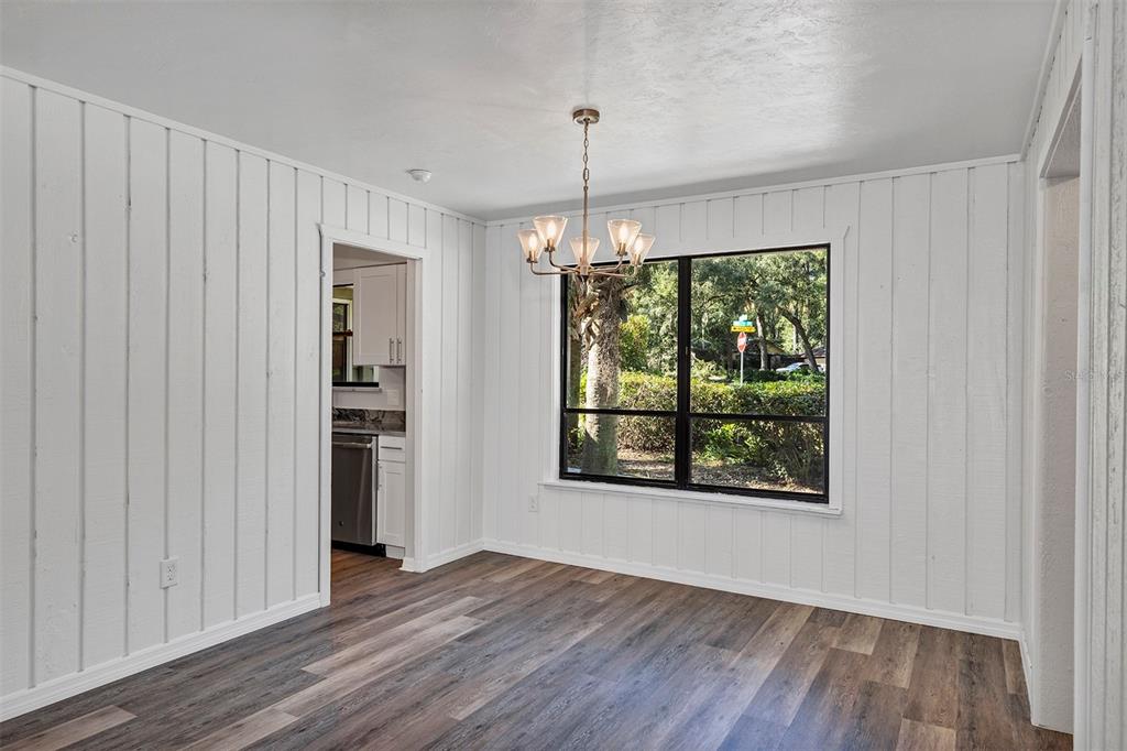 309 Southwest 77th Terrace Gainesville, FL 32607 - Photo 11 of 59 wooden floor in an empty room with a window