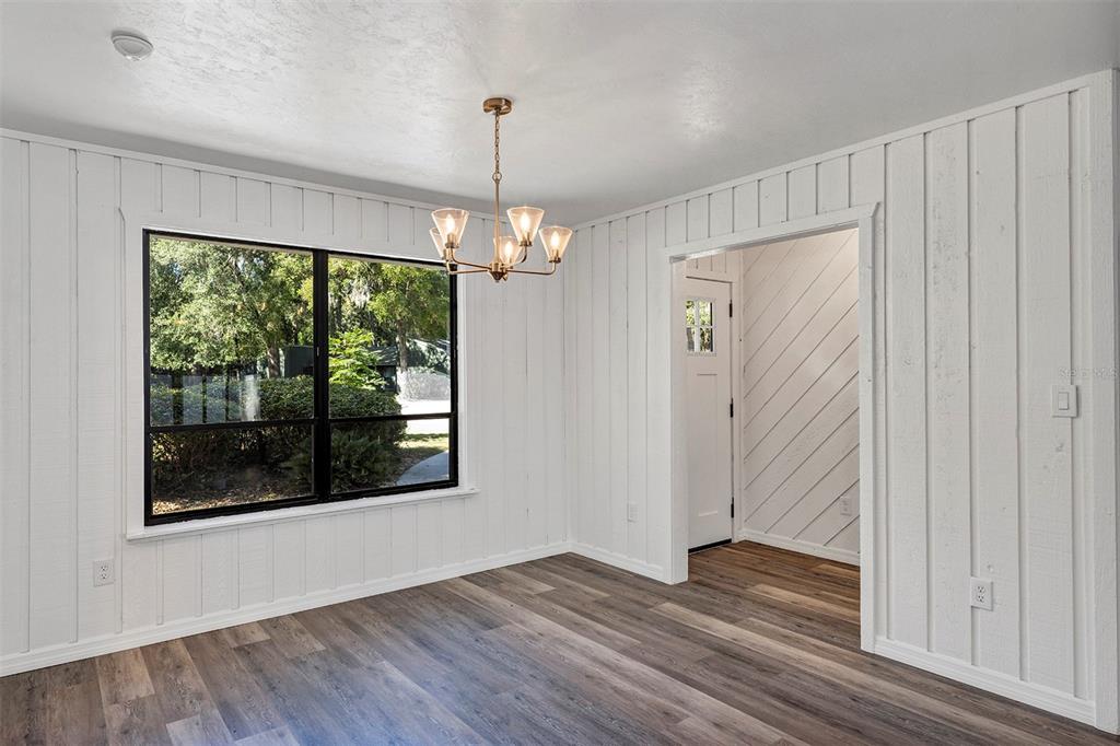 309 Southwest 77th Terrace Gainesville, FL 32607 - Photo 12 of 59 a view of an empty room with wooden floor and a window