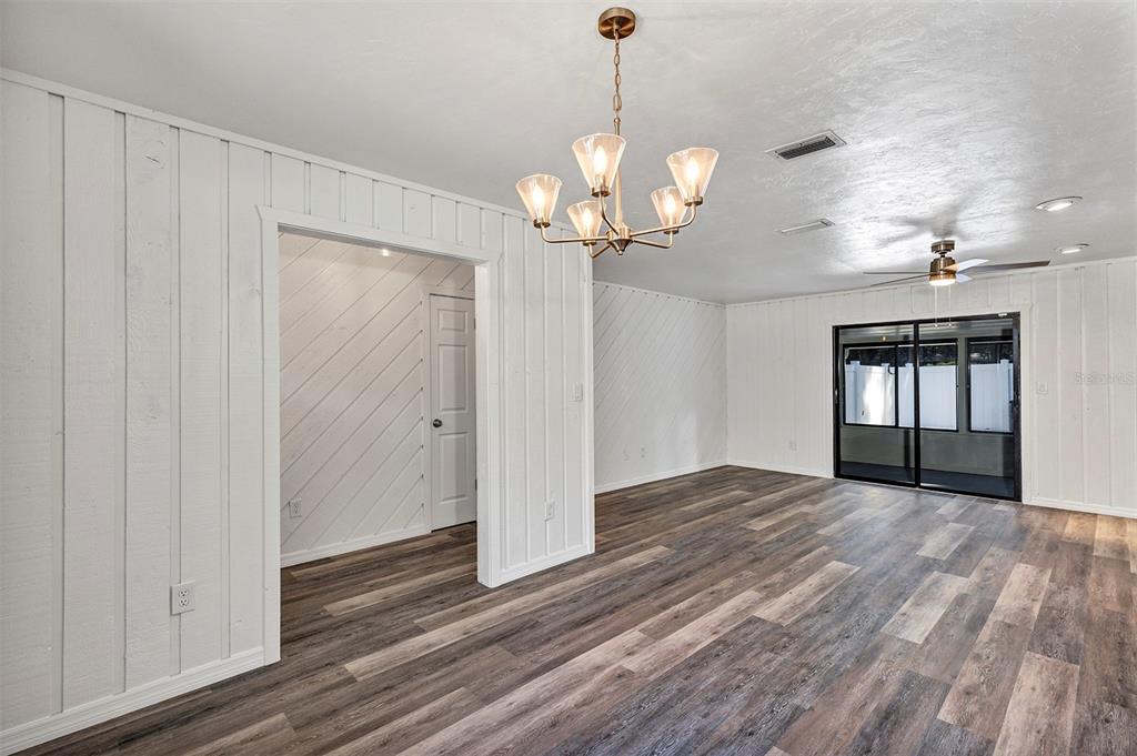 309 Southwest 77th Terrace Gainesville, FL 32607 - Photo 13 of 59 a view of a room with wooden floor chandelier and windows