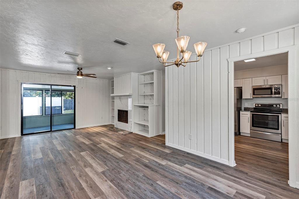309 Southwest 77th Terrace Gainesville, FL 32607 - Photo 14 of 59 a view of a kitchen with refrigerator and wooden floor