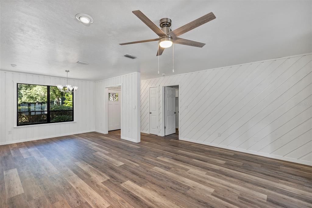 309 Southwest 77th Terrace Gainesville, FL 32607 - Photo 17 of 59 an empty room with wooden floor fan and windows
