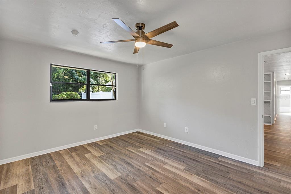 309 Southwest 77th Terrace Gainesville, FL 32607 - Photo 20 of 59 a view of empty room with wooden floor and fan