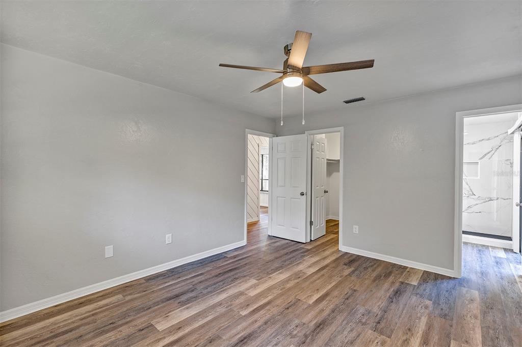 309 Southwest 77th Terrace Gainesville, FL 32607 - Photo 21 of 59 wooden floor in an empty room with a window