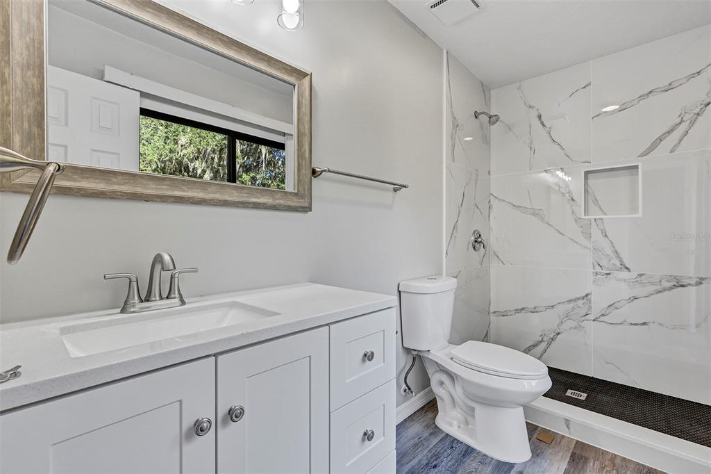 309 Southwest 77th Terrace Gainesville, FL 32607 - Photo 24 of 59 a bathroom with a toilet sink and mirror