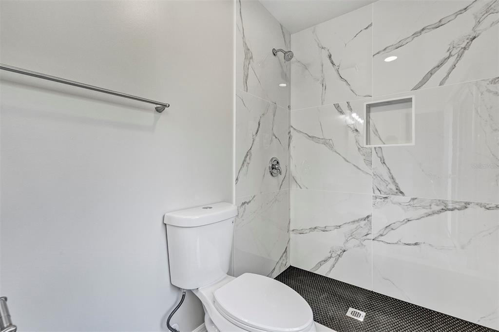 309 Southwest 77th Terrace Gainesville, FL 32607 - Photo 25 of 59 a white toilet sitting next to a bathroom sink