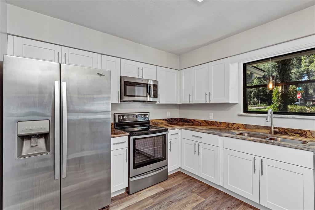 309 Southwest 77th Terrace Gainesville, FL 32607 - Photo 28 of 59 a kitchen with a sink stainless steel appliances and cabinets