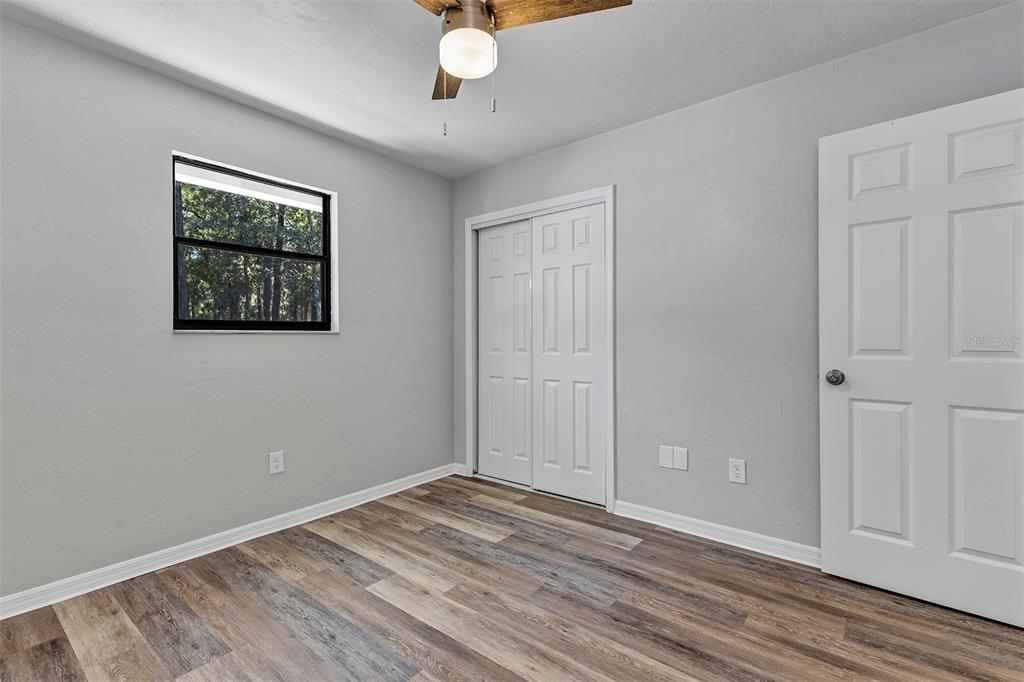 309 Southwest 77th Terrace Gainesville, FL 32607 - Photo 33 of 59 a view of empty room with wooden floor and fan