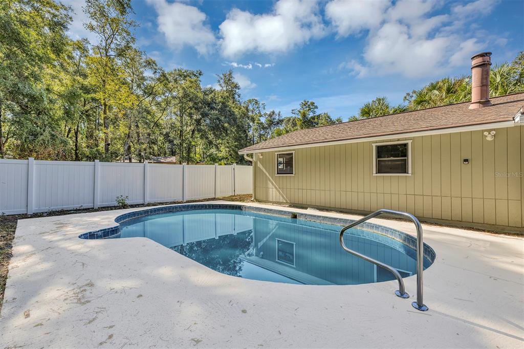 309 Southwest 77th Terrace Gainesville, FL 32607 - Photo 46 of 59 a view of backyard with swimming pool and outdoor space