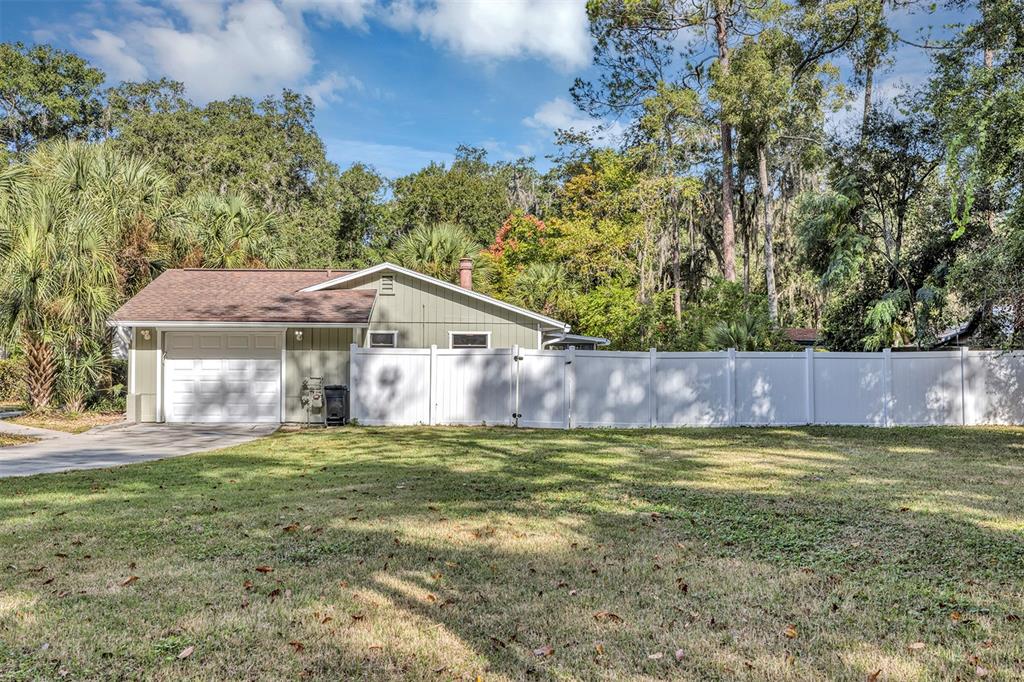 309 Southwest 77th Terrace Gainesville, FL 32607 - Photo 6 of 59 a view of a house with a yard and a large tree