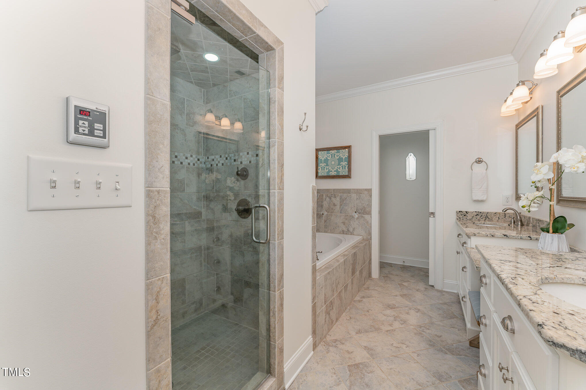 229 Robbins Road Durham, NC 27703 - Photo 12 of 26 a bathroom with a granite countertop sink a mirror a bathtub and shower