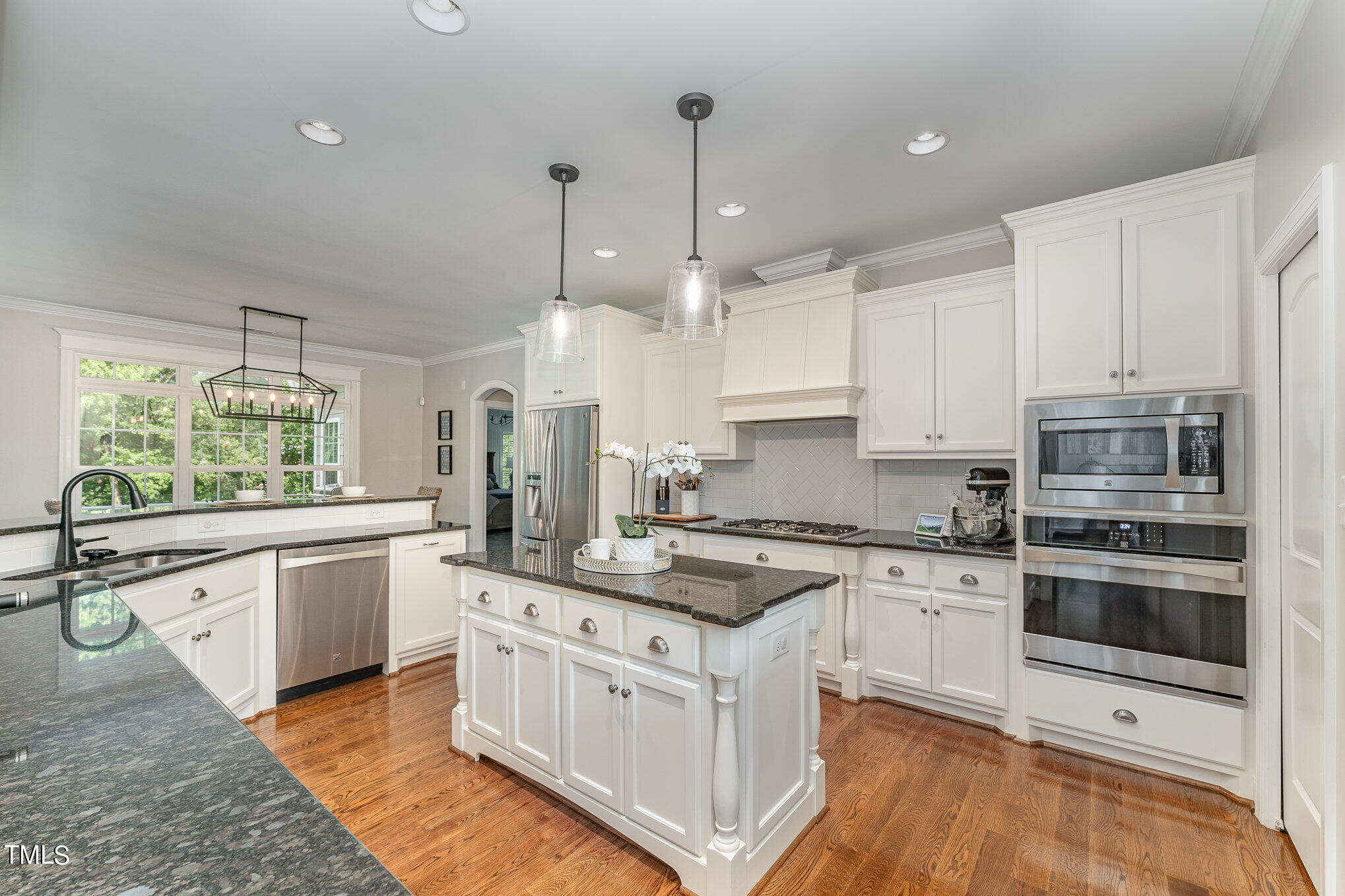 229 Robbins Road Durham, NC 27703 - Photo 13 of 26 a large white kitchen with stainless steel appliances granite countertop a stove a sink dishwasher and a refrigerator