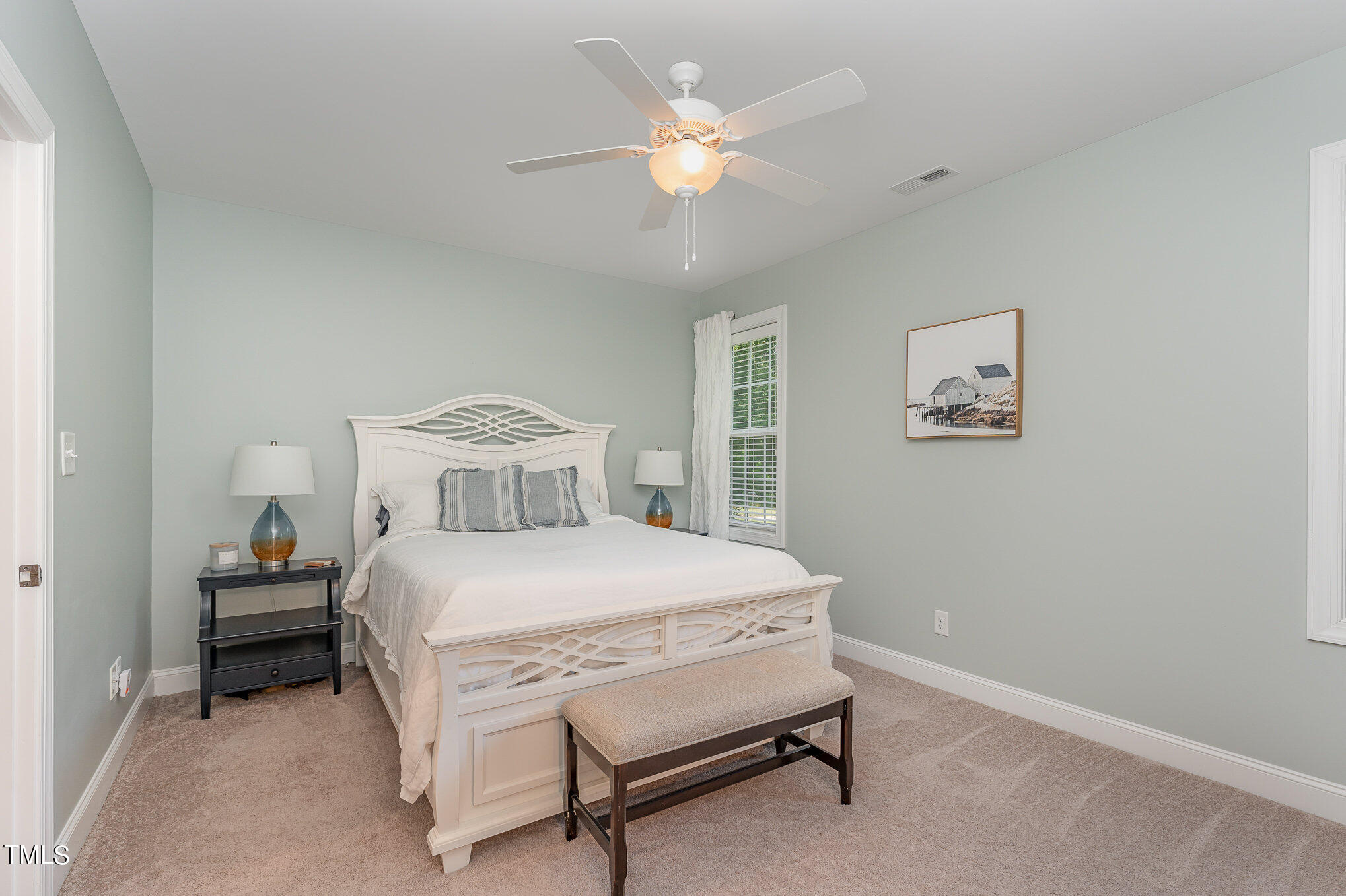 229 Robbins Road Durham, NC 27703 - Photo 15 of 26 a bedroom with a bed and a chandelier