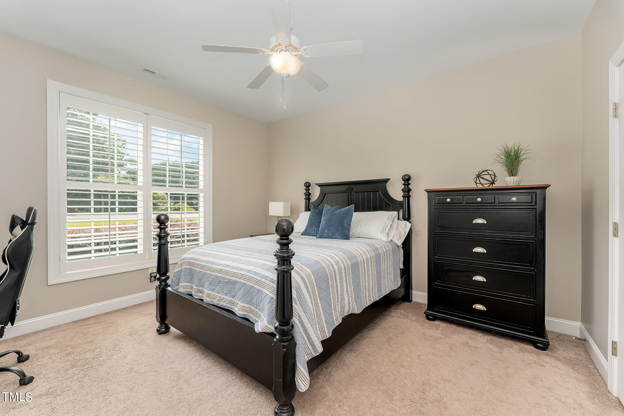 229 Robbins Road Durham, NC 27703 - Photo 18 of 26 a bedroom with a bed and a table