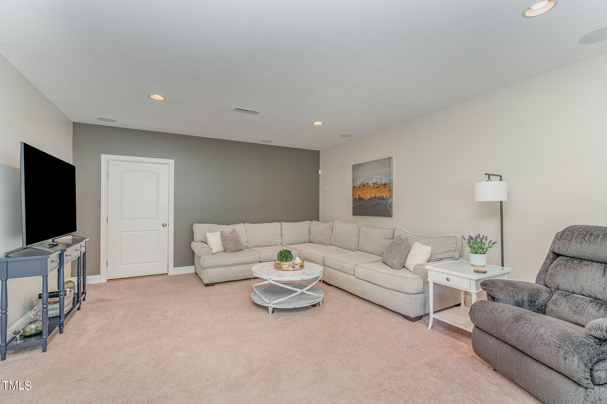 229 Robbins Road Durham, NC 27703 - Photo 25 of 26 a living room with furniture and a flat screen tv