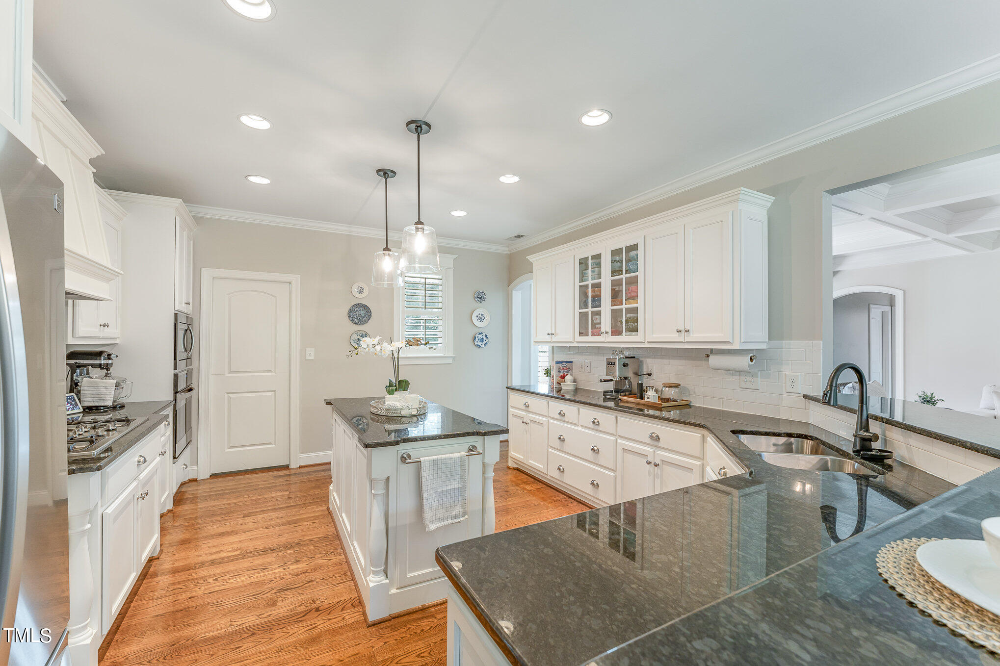 229 Robbins Road Durham, NC 27703 - Photo 7 of 26 a kitchen with stainless steel appliances granite countertop a sink and a refrigerator