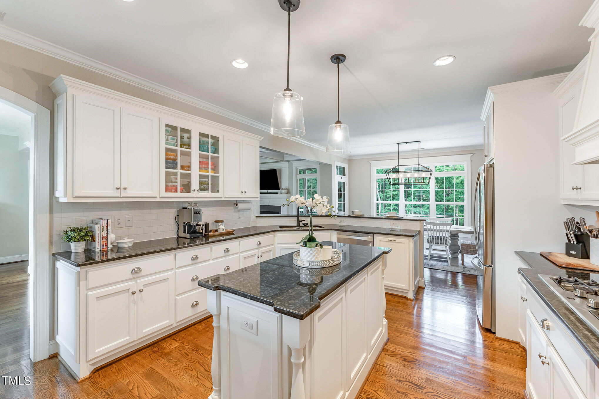 229 Robbins Road Durham, NC 27703 - Photo 9 of 26 a kitchen with granite countertop a sink stove and refrigerator