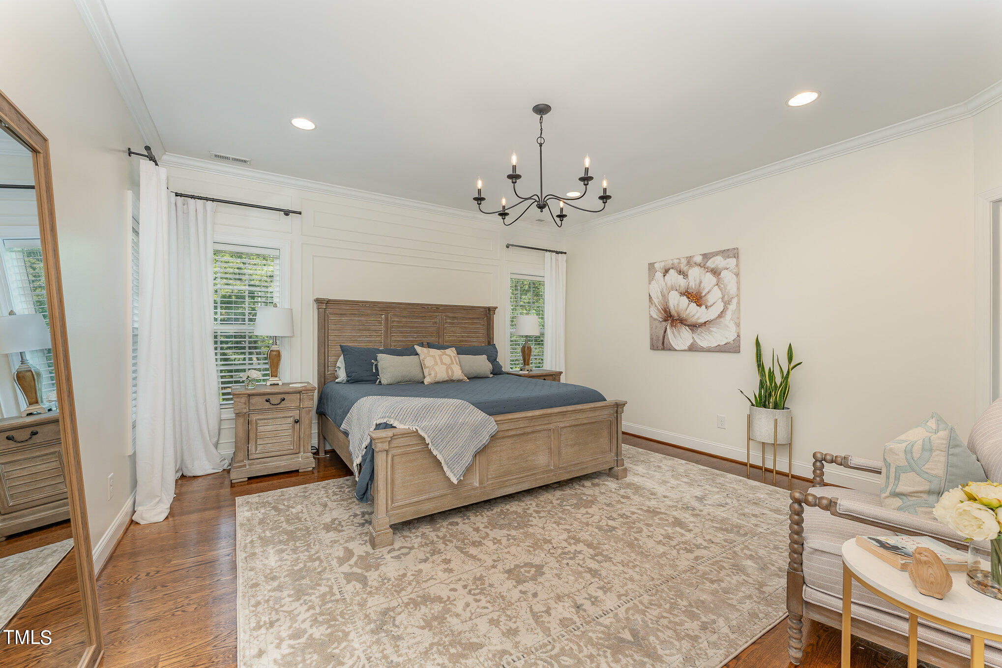 229 Robbins Road Durham, NC 27703 - Photo 10 of 26 a bedroom with a bed and a chandelier