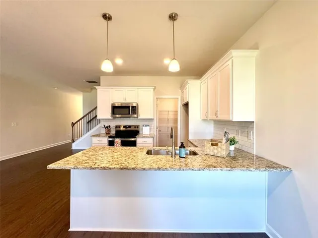 a view of a room with wooden floor