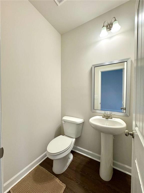 6346 Pine Ridge Point Lula, GA 30554 - Photo 26 of 26 a bathroom with a toilet sink and mirror