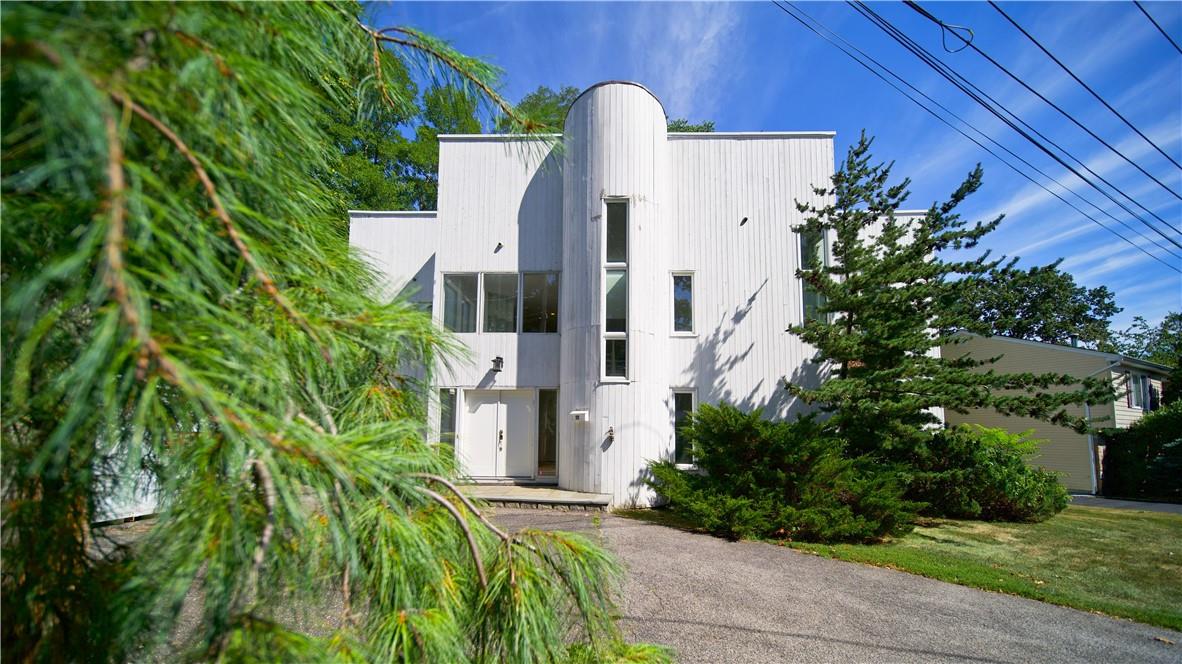 aerial view of a house with a yard and plants