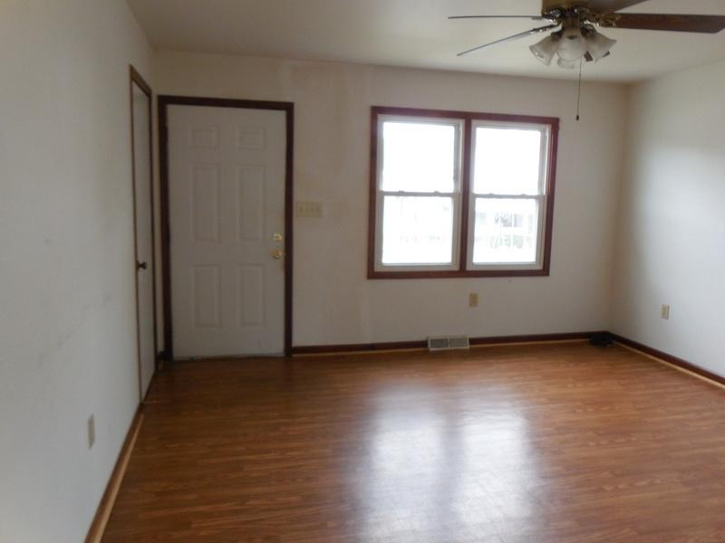 401 Rutherford Avenue Northwest Roanoke, VA 24016 - Photo 4 of 12 an empty room with wooden floor and windows