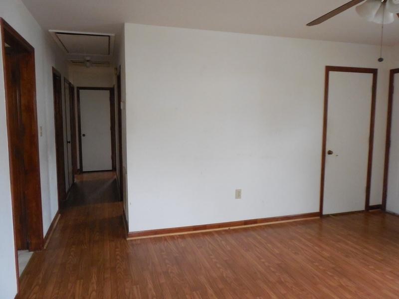 401 Rutherford Avenue Northwest Roanoke, VA 24016 - Photo 5 of 12 a view of an empty room with wooden floor and closet