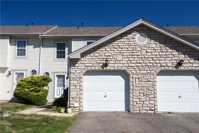 a front view of a house with a garage