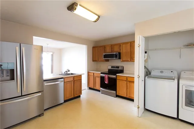 a kitchen with a refrigerator stove and sink