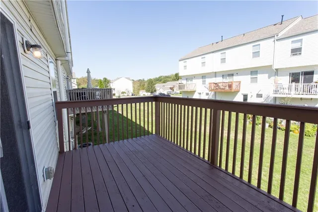 a view of a balcony with wooden floor