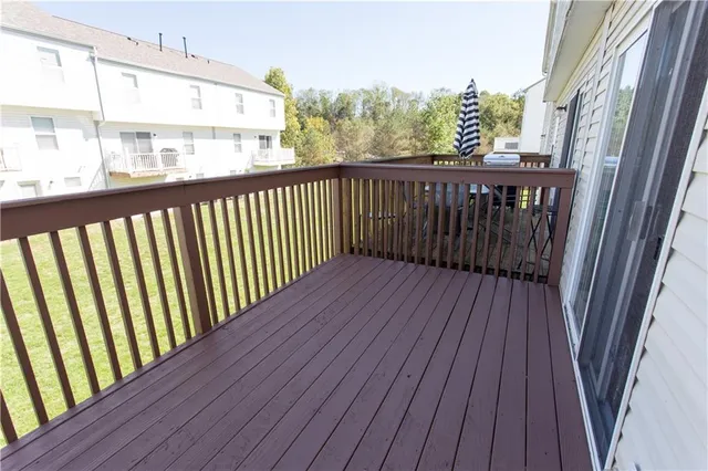 a view of a balcony with wooden floor