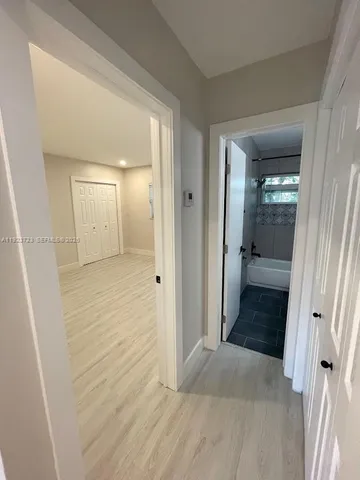 wooden floor with a bathroom