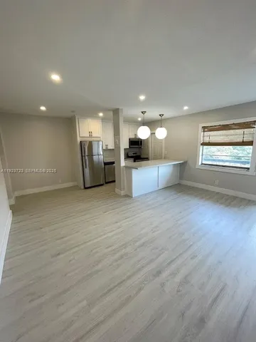 a view of a kitchen with a sink and a large window