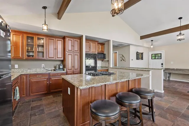 a kitchen with sink cabinets and dining table