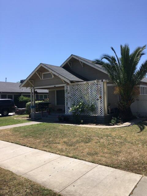 1315 D Street Reedley, CA 93654 - Photo 1 of 8 a front view of a house with a yard and garage