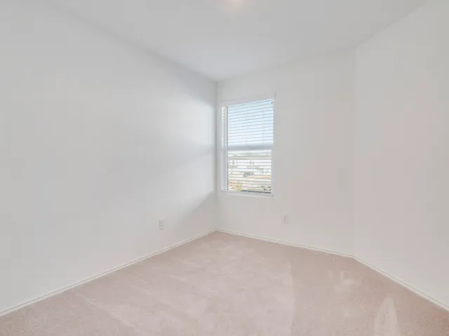 a view of an empty room and a window