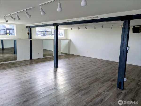 a view of a hallway with wooden floor