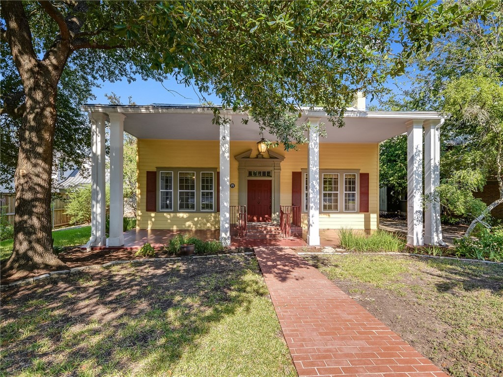 a front view of a house with a yard and outdoor seating