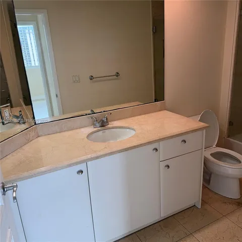 a bathroom with a sink toilet and vanity