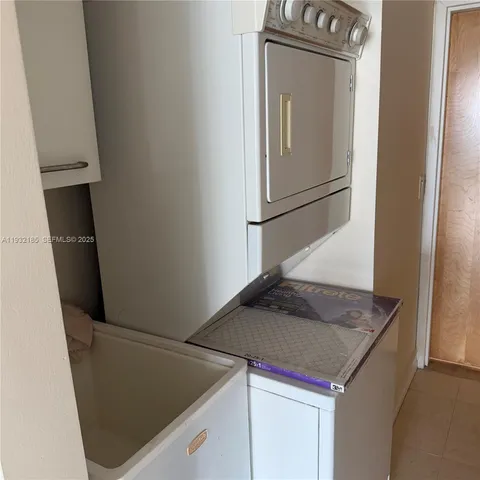 a kitchen with a sink and a refrigerator