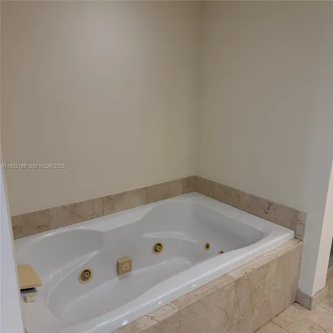a bath tub sitting next to a white sink