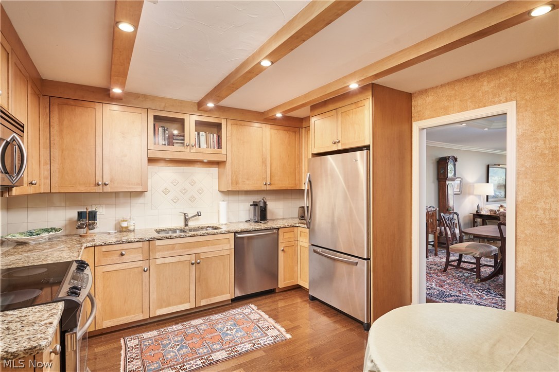 2385 Covington Road, Unit 304 Fairlawn, OH 44313 - Photo 10 of 21 Kitchen with glass insert cabinets, light stone countertops, light brown cabinets, appliances with stainless steel finishes, and recessed lighting