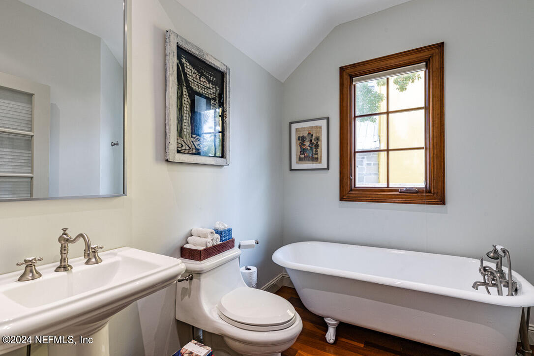 322 6th Street Atlantic Beach, FL 32233 - Photo 15 of 26 a bathroom with a toilet a sink and a window