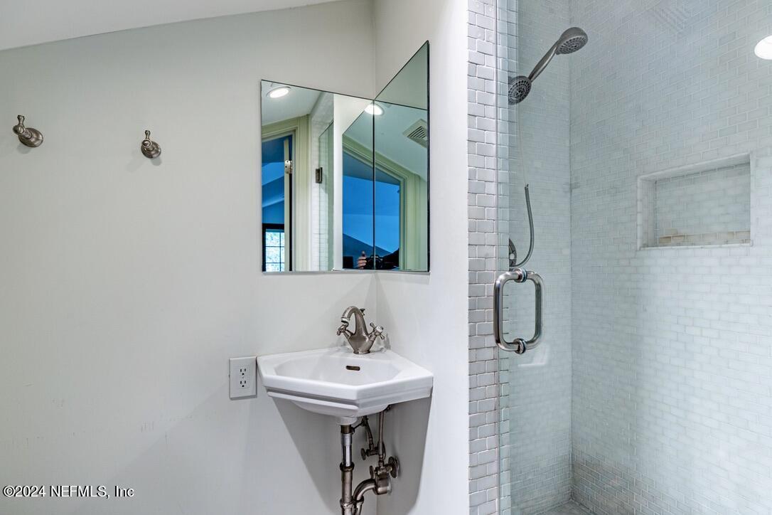 322 6th Street Atlantic Beach, FL 32233 - Photo 26 of 26 a bathroom with a sink a mirror and shower