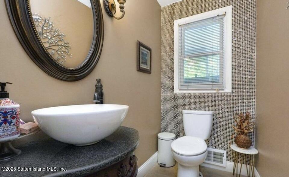 160 Rathbun Avenue Staten Island, NY 10312 - Photo 12 of 37 a bathroom with a toilet sink and mirror